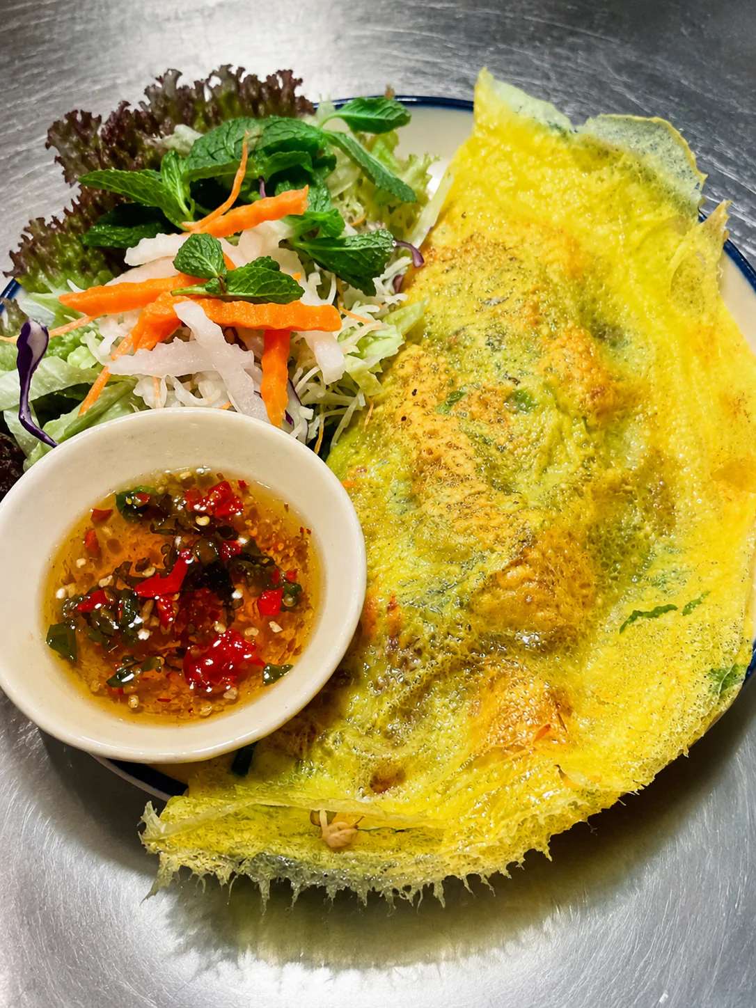 A crisp yellow crêpe with salad and dipping sauce at Saigon Sister Riccarton