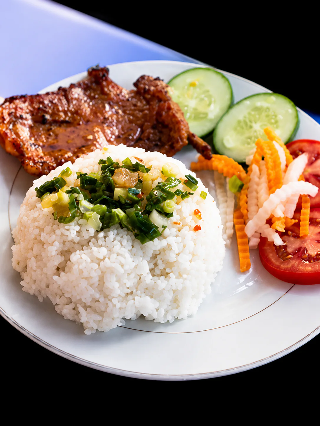 Rice, grilled meat and fresh vegetables on a plate at Saigon Sister Riccarton